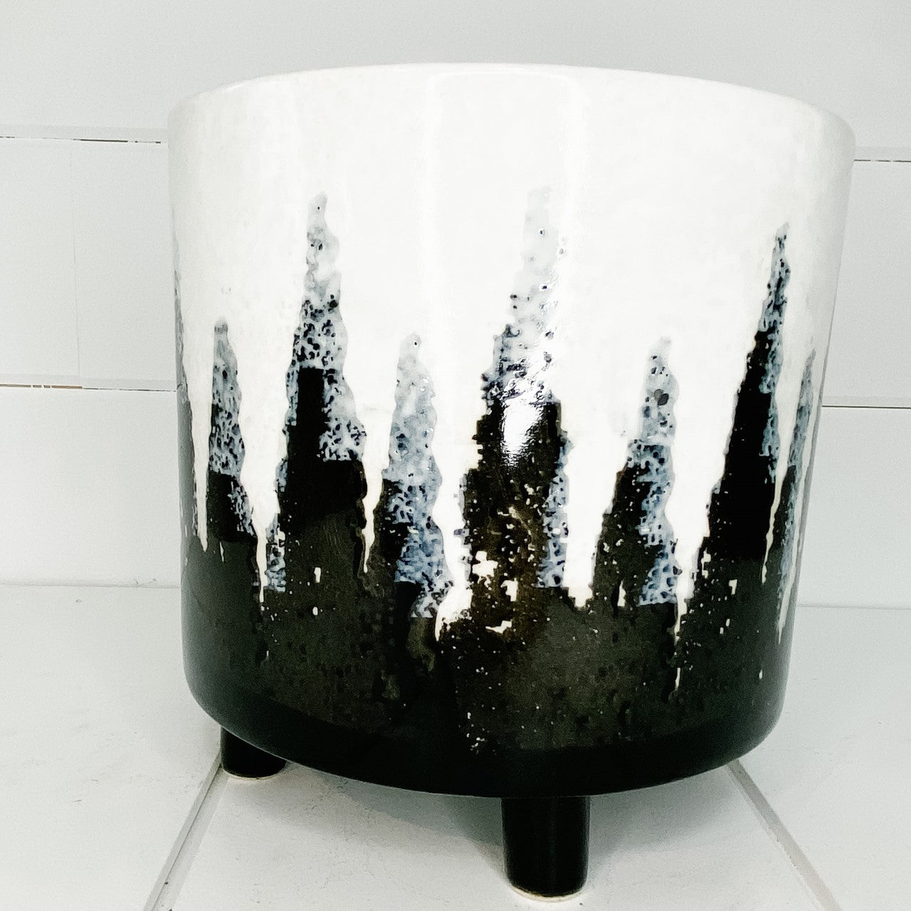 Ivory/Black ceramic planter with feet.