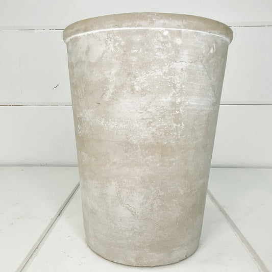 Tall cement planter.