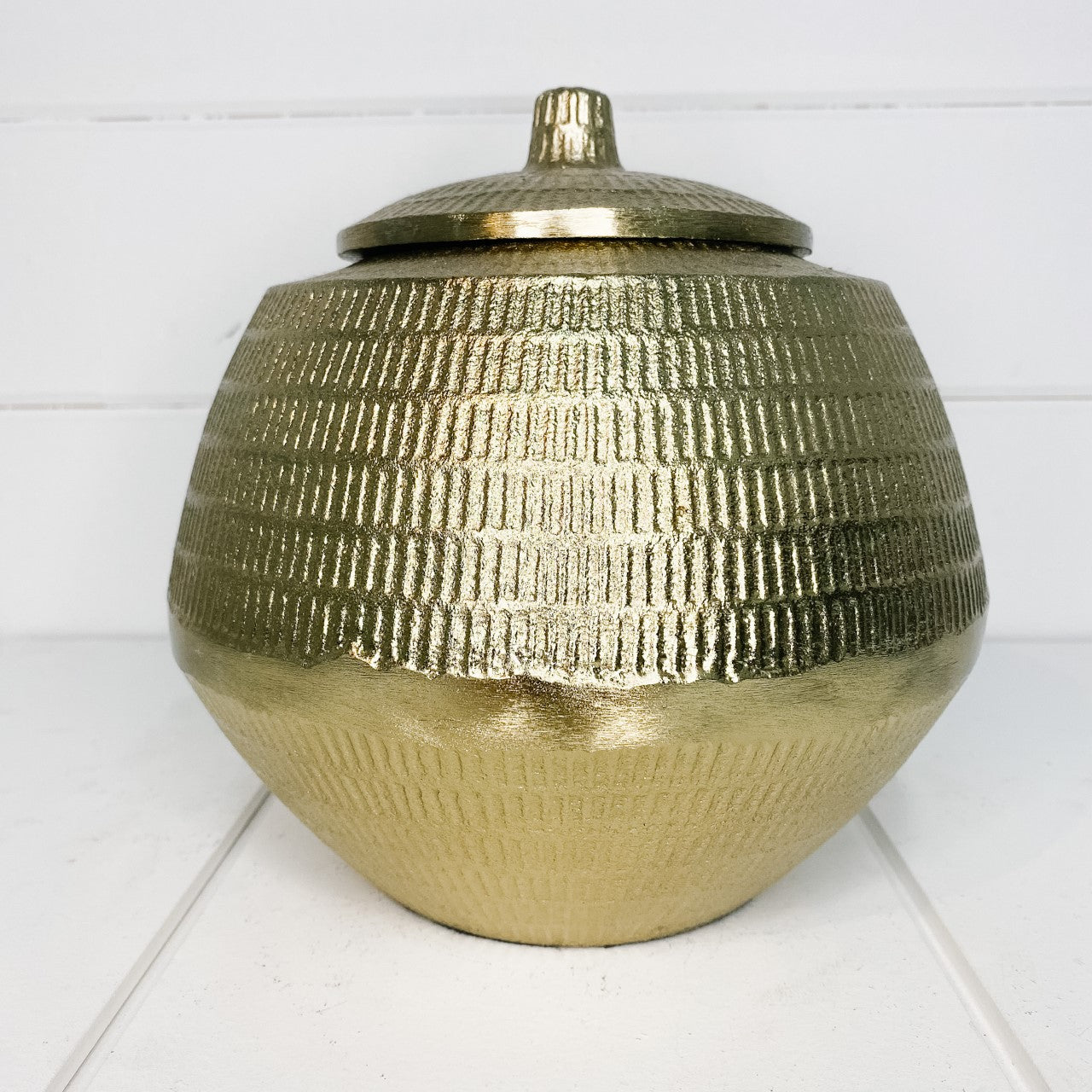 Gold metal urn with lid.