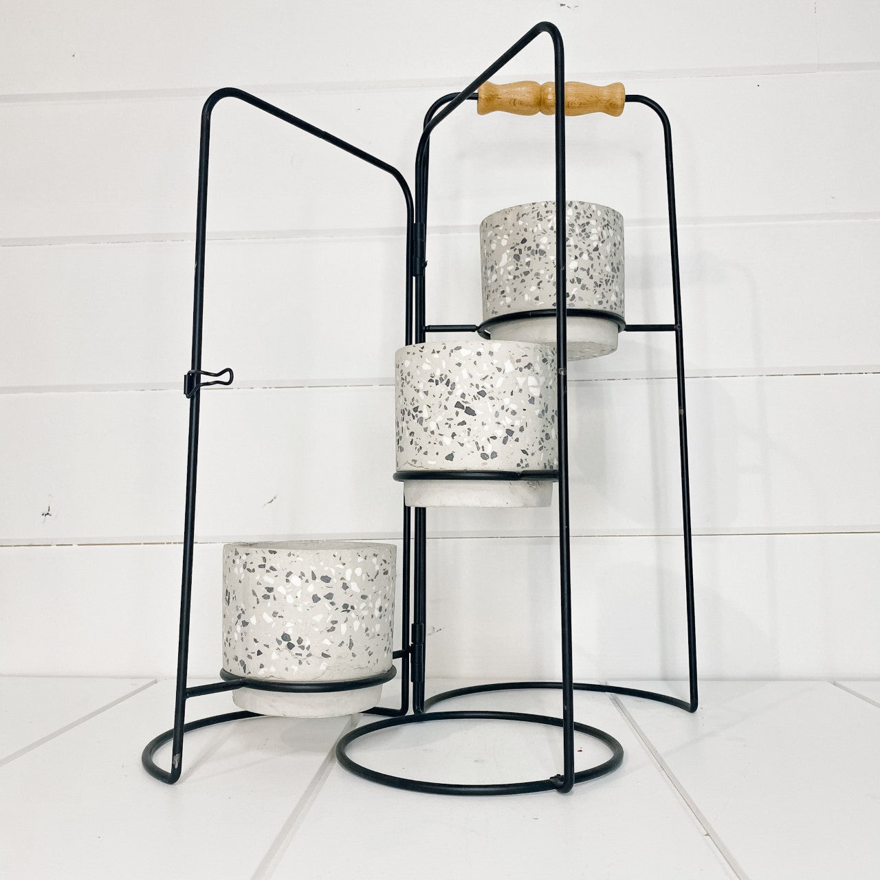Plant stand with cement speckled pots.