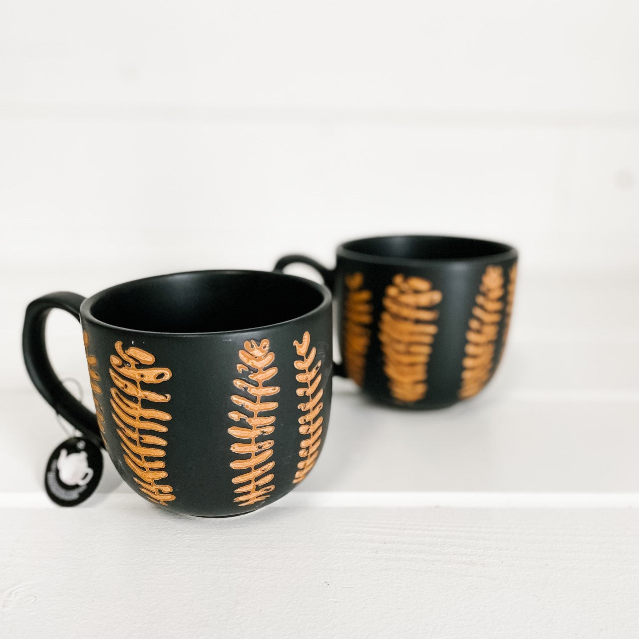 Black mugs with Terracotta leaf design